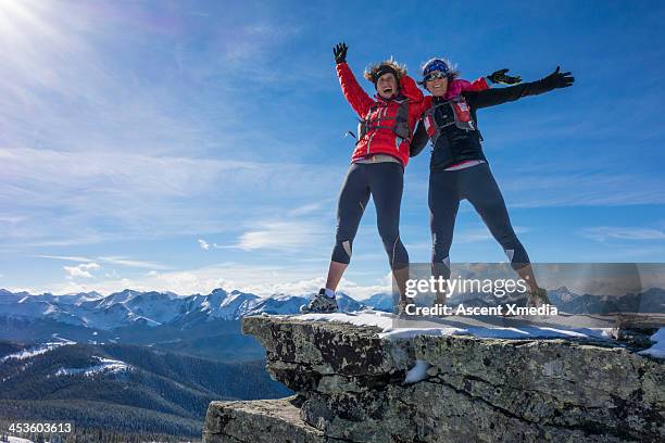 two ladies celebrate success together on mt summit - summit day 2 stock pictures, royalty-free photos & images