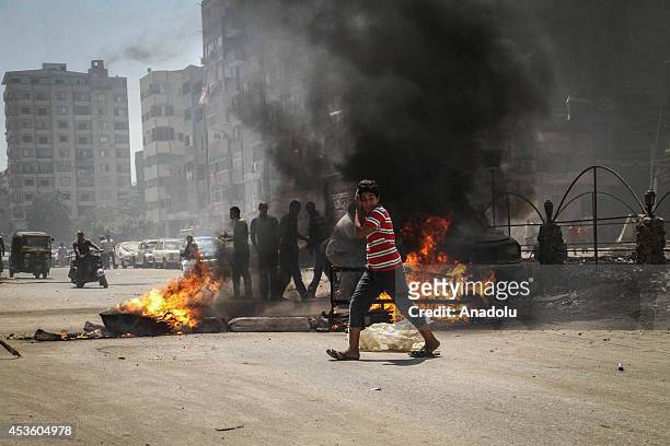 Anti-coup protestors clash with security forces during a demonstration on World Rabaa Day marking the 1st anniversary of the killing of hundreds of...