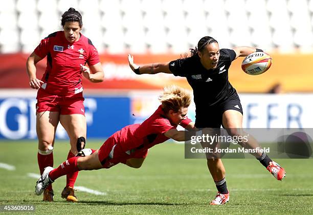 Honey Hireme of New Zealand is tackled by Philippa Tuttiett of Wales during the IRB Women's Rugby World Cup 5th place match between New Zealand and...