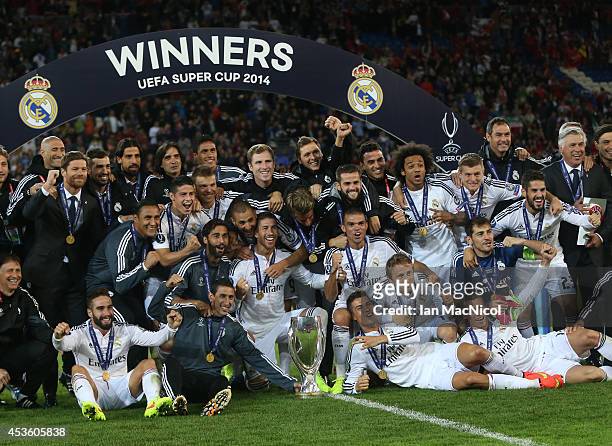 Real Madrid players celebrate with the trophy during the UEFA Super Cup match between Real Madrid and Sevilla at Cardiff City Stadium on August 12,...