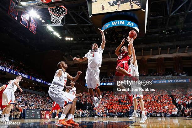 Traevon Jackson of the Wisconsin Badgers drives to the basket against Justin Anderson of the Virginia Cavaliers during the first half of the Big...