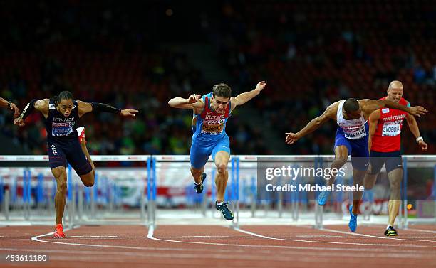 Pascal Martinot-Lagarde of France, Sergey Shubenkov of Russia and William Sharman of Great Britain and Northern Ireland cross the finish line in the...