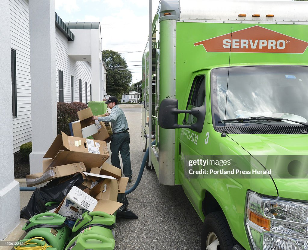 Servpro workers cleanup offices that were flooded