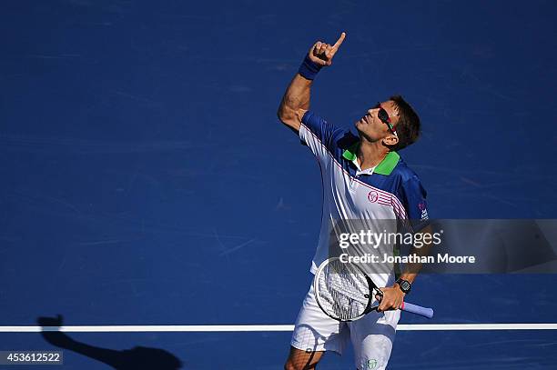 Tommy Robredo of Spain celebrates after defeating number one ranked Novak Djokovic of Serbia after a match on day 6 of the Western & Southern Open at...