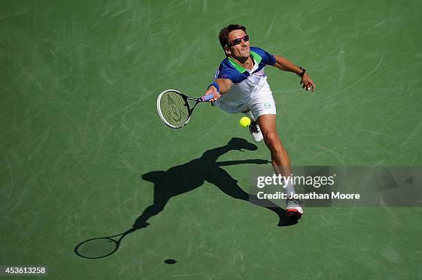 Tommy Robredo of Spain returns to Novak Djokovic of Serbia during a match on day 6 of the Western & Southern Open at the Linder Family Tennis Center...