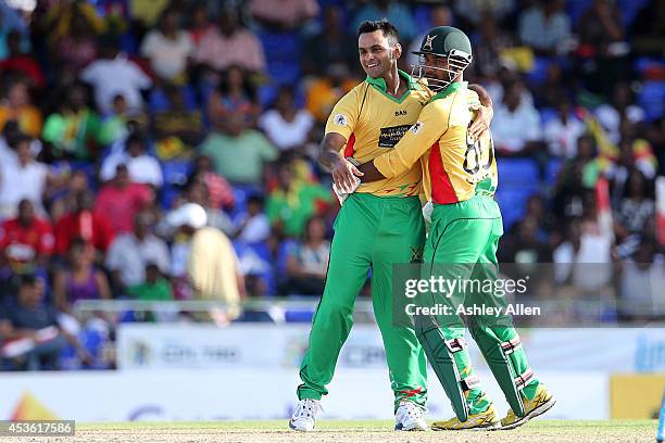 Mohammed Hafeez celebrates with Denesh Ramdin during a Semifinal match between Jamaica Tallawahs and Guyana Amazon Warriors as part of the Limacol...