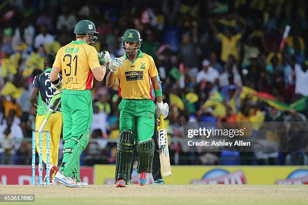 Lendl Simmons congratulates Martin Guptill on reaching 50 during a Semifinal match between Jamaica Tallawahs and Guyana Amazon Warriors as part of...