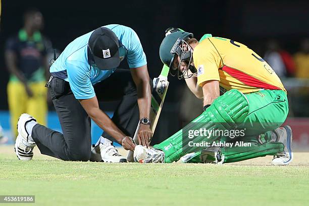 Umpire Gregory Brathwaite fixes Martin Guptill's boot during the Semifinal match between Jamaica Tallawahs and Guyana Amazon Warriors as part of the...