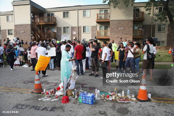 Demonstrators protest at the spot where teenager Michael Brown was killed on August 14, 2014 in Ferguson, Missouri. Brown was shot and killed by a...