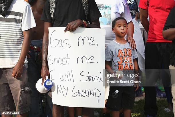 Demonstrator holds a sign during a protest of the shooting death of teenager Michael Brown on August 14, 2014 in Ferguson, Missouri. Brown was shot...
