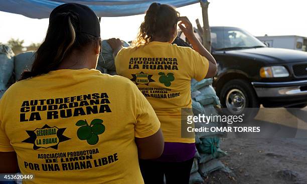 Members of the Citizens' Self-Protection vigilante group --one of many created by locals to protect communities from organized crime-- stand in a...