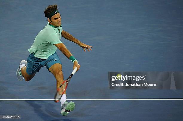 Roger Federer of Switzerland returns to Gael Monfils of France during a match on day 6 of the Western & Southern Open at the Linder Family Tennis...