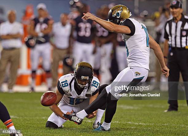 Josh Scobee of the Jacksonville Jaguars kicks a field goal as Bryan Anger hold during the second quarter of a preseason game at Soldier Field on...