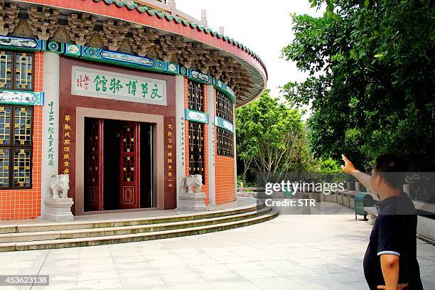 China-politics-history,FOCUS BY Felicia SONMEZ This picture taken on August 8, 2014 shows a man gustures before a hall of the Cultural Revolution...