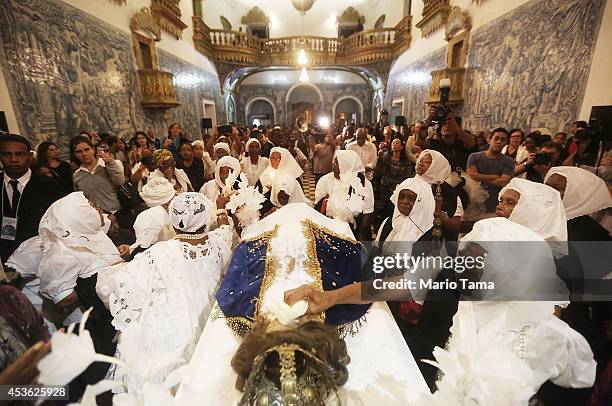 Members of the Sisterhood of the Good Death gather around a statue of the Virgin Mary after marching in a procession during the Festival of the Good...