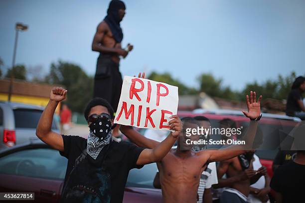 Demonstrators gather along West Florissant Avenue to protest the shooting death of Michael Brown on August 14, 2014 in Ferguson, Missouri. Violent...