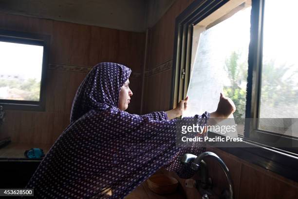 Palestinian women inspects the damage of an Israeli air strike in her home at Khan Younis in the Southern of Gaza City. According to the Palestinians...