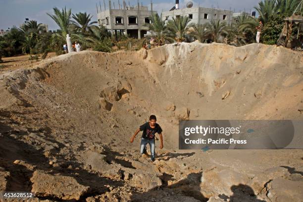 Palestinian boy inspects the damage of an Israeli air strike in some parts of Khan Younis in the Southern of Gaza City. According to the Palestinians...