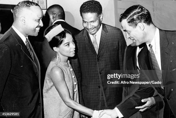 Ruby Dee shakes the hand of politician Henry Parks at a banquet for her husband Ossie Davis, 1967.