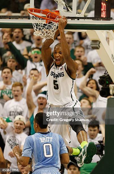 Adreian Payne of the Michigan State Spartans reacts after a first half dunk behind Nate Britt of the North Carolina Tar Heels at the Jack T. Breslin...