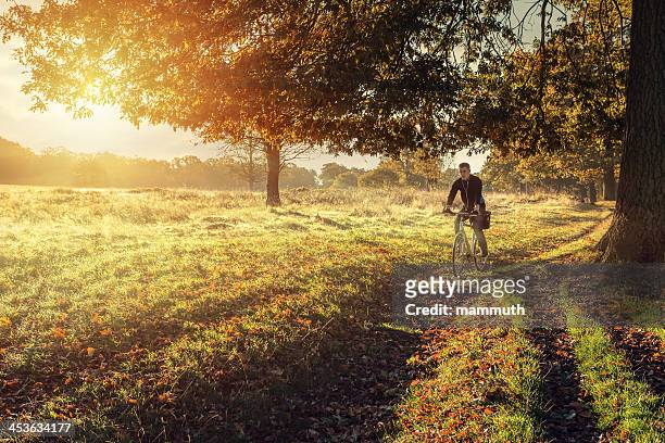 young man cycling in the morning - richmond park london stock pictures, royalty-free photos & images