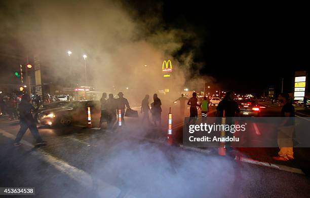 Demonstrators take part in a rally on West Florissant Avenue to protest the shooting death of an unarmed teen by a police officer in Ferguson,...