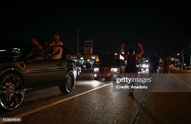 Demonstrators take part in a rally on West Florissant Avenue to protest the shooting death of an unarmed teen by a police officer in Ferguson,...
