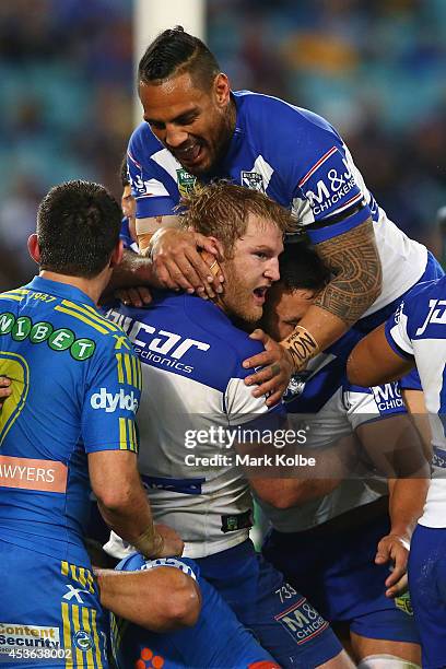 Reni Maitua of the Bulldogs celebrates with Aiden Tolman of the Bulldogs after he scored a try during the round 23 NRL match between the Parramatta...