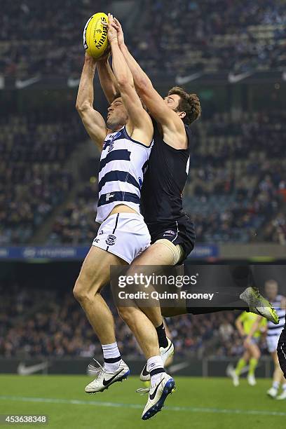 Jared Rivers of the Cats marks infront of Levi Casboult of the Blues during the the round 21 AFL match between the Carlton Blues and the Geelong Cats...