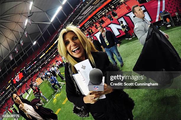 Network sideline reporter Laura Okmin heads off the field after the game between the Atlanta Falcons and the New Orleans Saints at the Georgia Dome...