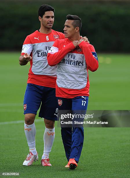 Mikel Arteta and Alexis Sanchez of Arsenal during a training session at London Colney on August 15, 2014 in St Albans, England.