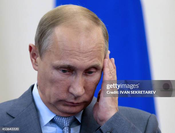 Russian President Vladimir Putin listens to a question during a press conference with his Finnish counterpart after talks at the Black Sea resort of...