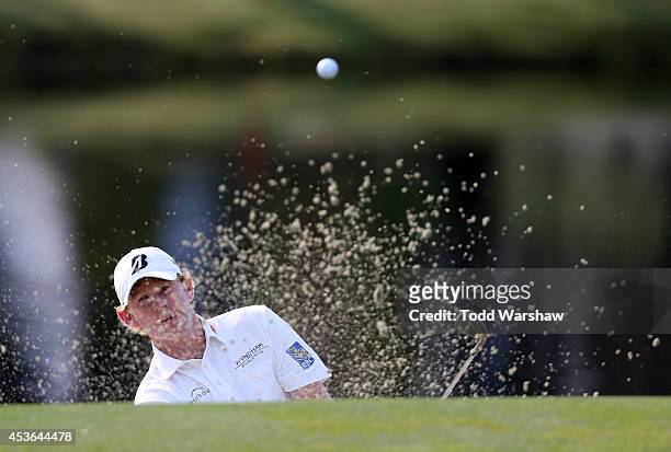 Brandt Snedeker chips out of the bunker on the 15th hole during the second round of the Wyndham Championship at Sedgefield Country Club on August 15,...