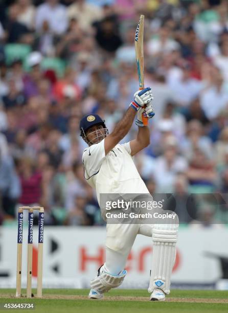 Mahendra Singh Dhoni of India hits out for six runs during day one of 5th Investec Test match between England and India at The Kia Oval on August 15,...