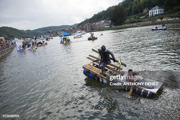 Man paddles as he takes part in an international bathtub regatta in Dinant, on August 15, 2014. AFP PHOTO/BELGA/ANTHONY DEHEZ -Belgium Out-
