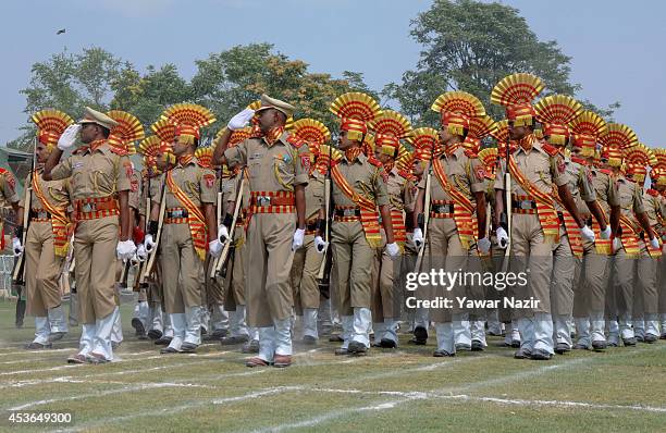 Contingent of Indian paramilitary force takes salute during India's Independence Day celebrations on August 15, 2014 in Srinagar, the summer capital...