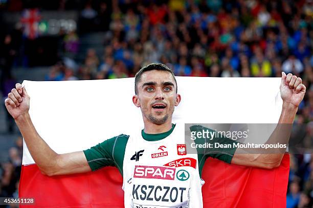 Adam Kszczot of Poland celebrates with the Polish national flag after winning gold in the Men's 800 metres final during day four of the 22nd European...