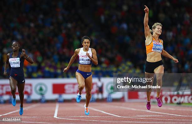 Dafne Schippers of the Netherlands celebrates after winning gold next to silver medalist Jodie Williams of Great Britain and bronze medalist Myriam...