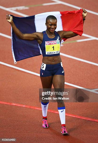 Antoinette Nana Djimou of France celebrates with the French national flag as she celebrates winning gold in the Women's Heptathlon during day four of...