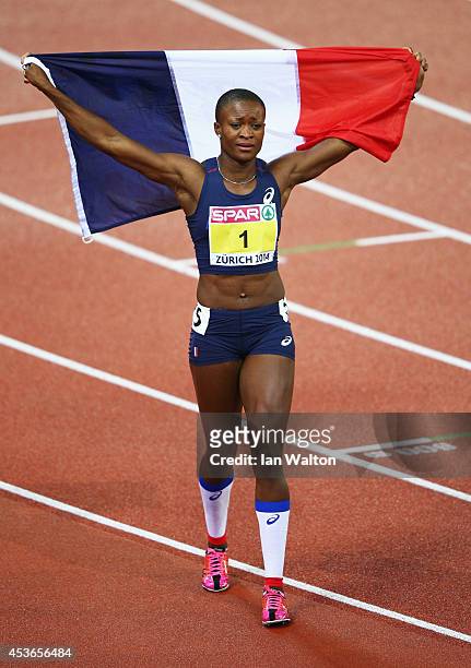 Antoinette Nana Djimou of France celebrates with the French national flag as she celebrates winning gold in the Women's Heptathlon during day four of...