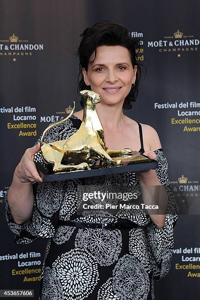 Actress Juliette Binoche poses with Excellence Award Moet&Chandon during the 67th Locarno Film Festival on August 15, 2014 in Locarno, Switzerland.