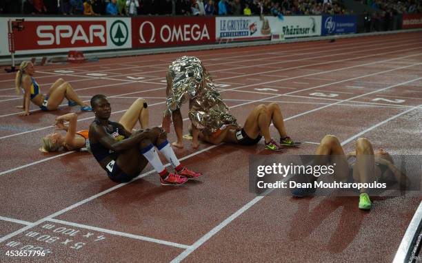 Antoinette Nana Djimou of France sits on the track with other heptathletes after the Women's Heptathlon 800 metres during day four of the 22nd...