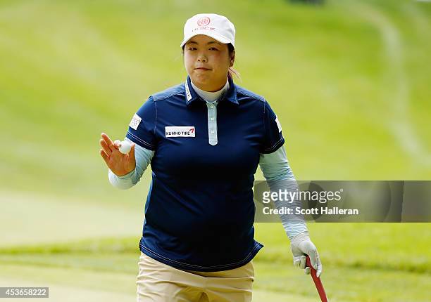 Shanshan Feng of China waves to the gallery on the 14th green during the second round of the Wegmans LPGA Championship at Monroe Golf Club on August...