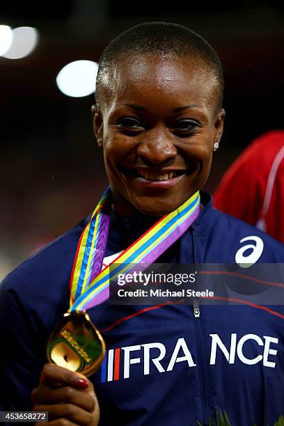 Gold medalist Antoinette Nana Djimou of France poses with her medal on the podium during the medal ceremony for the Women's Heptathlon during day...
