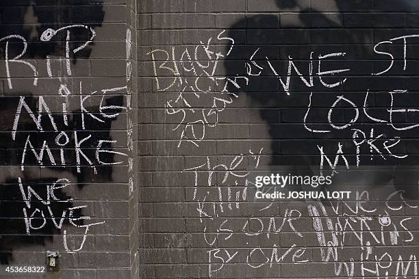 Demonstrators wrote messages while protesting on August 15 the shooting death of 18-year-old Michael Brown in Ferguson, Missouri. US authorities on...