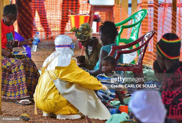 An MSF medical worker feeds an Ebola child victim at an MSF facility in Kailahun, on August 15, 2014. Kailahun along with Kenama district is at the...