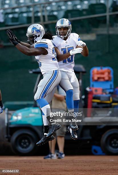 Wide recever Golden Tate and running back Joique Bell of the Detroit Lions celebrate against the Oakland Raiders during their preseason game at O.co...