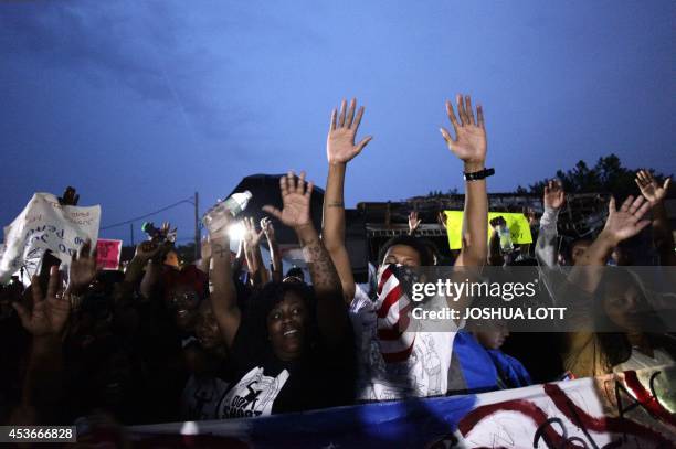 Demonstrators raise their hands as they protest the shooting death of 18-year-old Michael Brown on August 15, 2014 in Ferguson, Missouri. Michael...