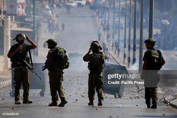 Four Israeli soldiers survey the streets of Bethlehem, as plumes and haze of tear gas smoke linger in the streets. As the extended, but fragile...