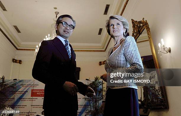 Indonesian Foreign Minister Marty Natalegawa and his Australian counterpart Julie Bishop pose for photographers as they meet in Jakarta on December...